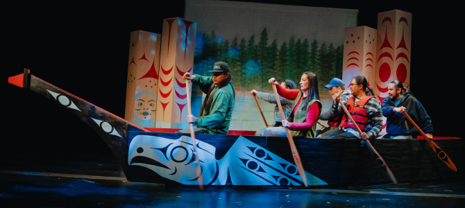 Image depicting people paddling in a canoe