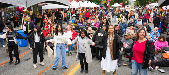 View of street party showing vendors and people walking