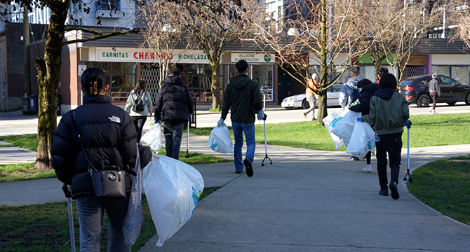 Group of people walking with garbage bags and  pickers