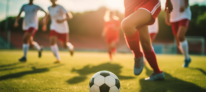 A kid kicks a soccer ball