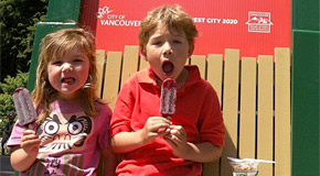 Kids eating locally-made popsicles at a park concession stand