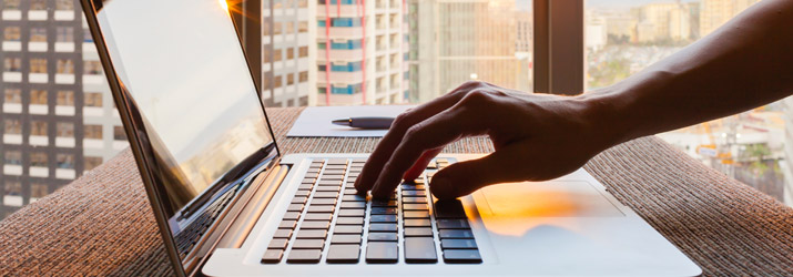 Laptop with apartments in the background