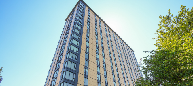 Featuring a low angle shot of a mass timber high-rise building