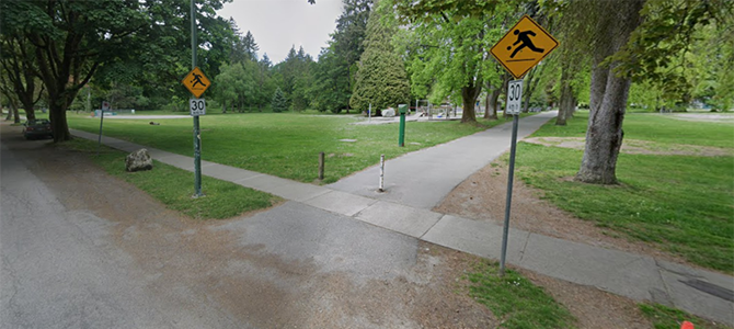 Entrance to Memorial West Park showing a paved path, pedestrian signs, and surrounding trees and green space. Entrance to Memorial West Park showing a paved path, pedestrian signs, and surrounding trees and green space.