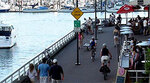 People walking and cycling along the Seawall on the north side of False Creek