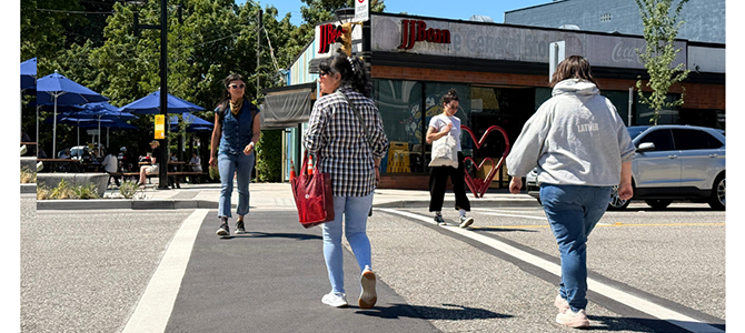 People using a pedestrian crossing at a neighbourhood intersection.