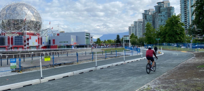 A person biking on the new Expo deck seawall path by Science World A person biking on the new Expo deck seawall path by Science World