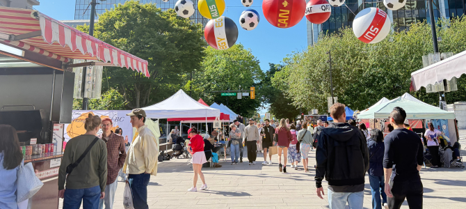 People walking outdoors at a street festival in nice weather