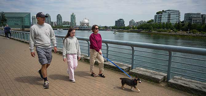 People walking their dog on a leash.