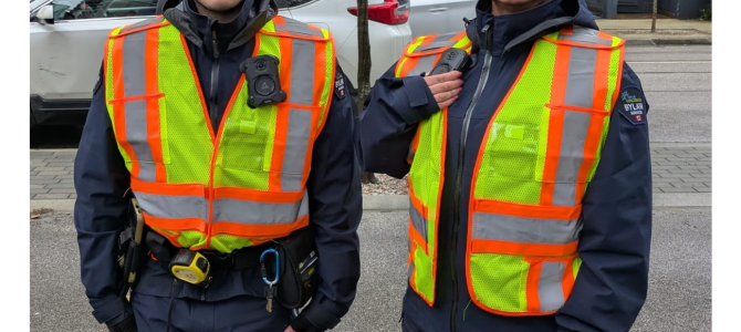 Two people wearing high-visibility vests 