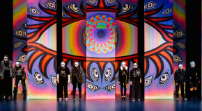 Performers on a stage in masks 