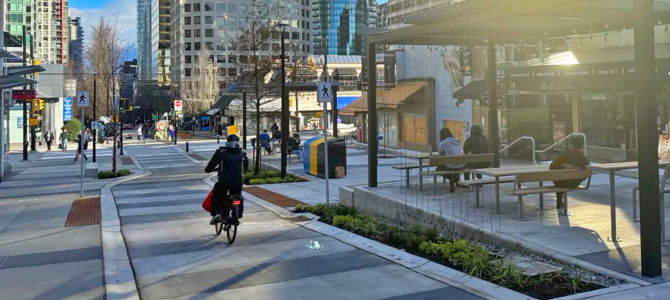A person bikes through the permanent Bute and Robson Plaza