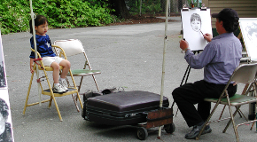 A girl poses for a portrait artist in Stanley Park