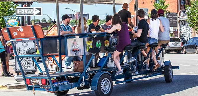 People using a quadricycle on street