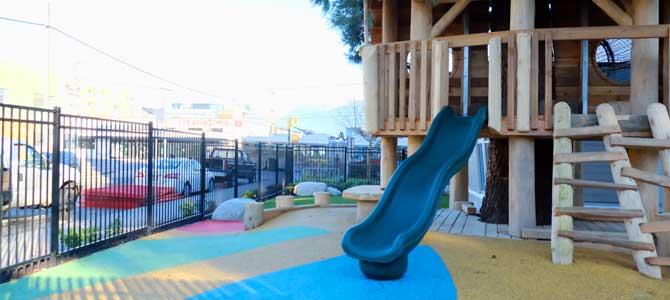 Slide and playground with a rubber floor at RayCam Community Centre