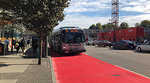 Bus driving down a lane painted red Bus driving down a lane painted red