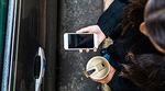 Person holding a cell phone in front of a car door Person holding a cell phone in front of a car door