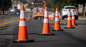 Orange traffic cones lined up on a road