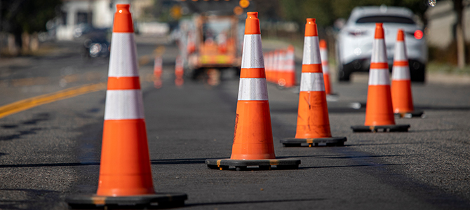 Orange traffic cones lined up on a road Orange traffic cones lined up on a road