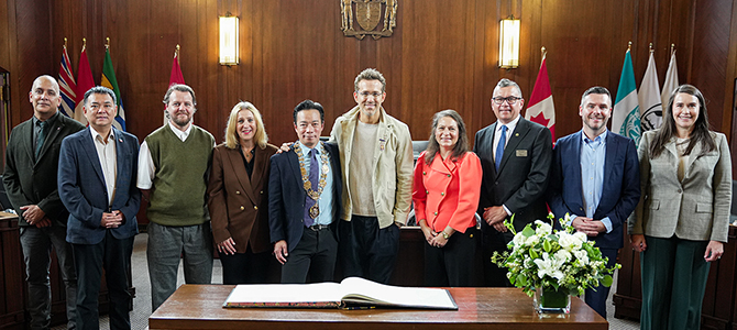 Ryan Reynolds standing alongside with Vancouver City Council members