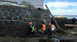 People restoring the wall at Third Beach People restoring the wall at Third Beach