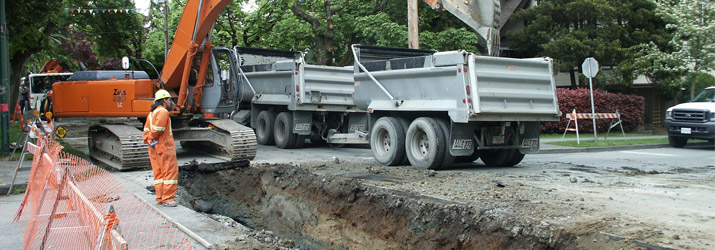 Sewer main construction - bulldozer and truck Sewer main construction - bulldozer and truck
