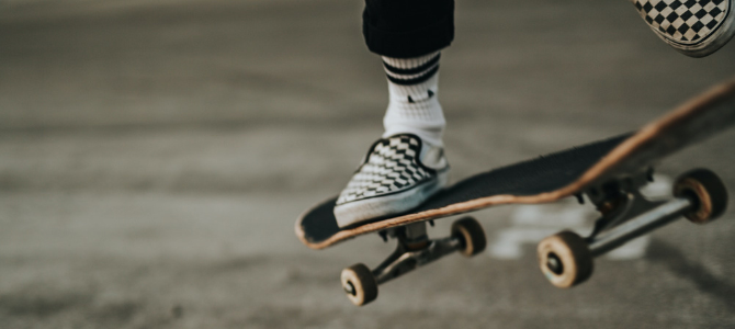 Close-up of a skateboarder's feet and board mid-air