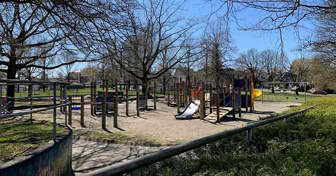 Southwest facing view of existing playground and wading pool