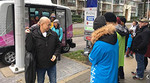Riders exiting an autonomous vehicle shuttle on Manitoba Street Riders exiting an autonomous vehicle shuttle on Manitoba Street