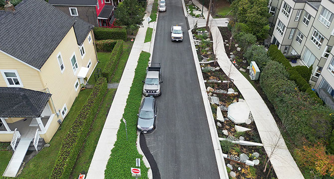 Aerial view of St George Rainway showing parked vehicles and newly installed paved areas, green areas, and gardens