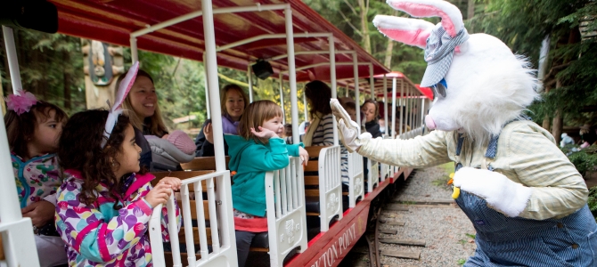 The Easter Bunny waves at children on Stanley Park's Easter train