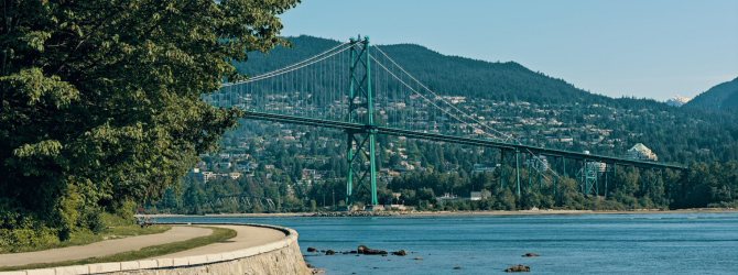 Stanley Park seawall with the Lions Gate Bridge in the background.