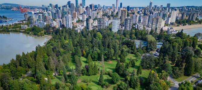 Stanley Park Pitch and Putt greens with downtown buildings in the background