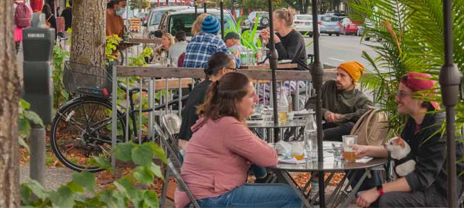 People sitting at tables on an outdoor patio