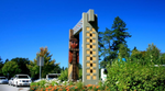 Public artwork by Susan Point featuring a Coast Salish figure and geometric archway.