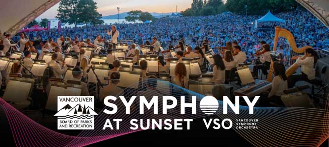 Musicians playing at Symphony at Sunset concert, a large crowd watching them. 