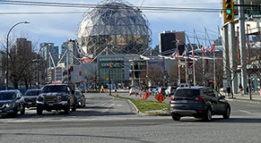 Terminal intersection open to cars and pedestrians with Science World in the background