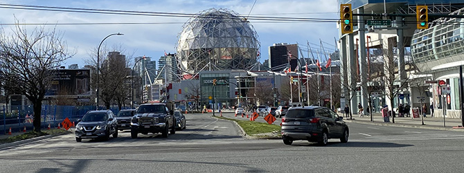 Terminal intersection open to cars and pedestrians with Science World in the background