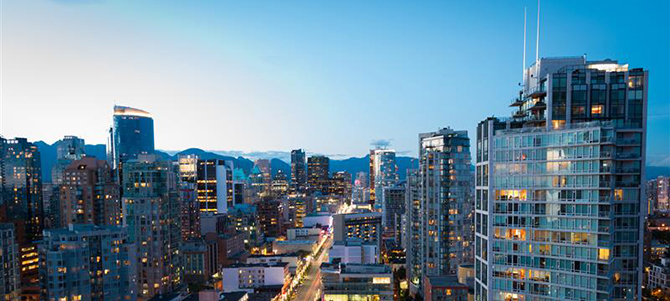 A high up view of a Vancouver street and city at dusk