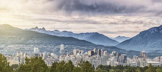 A cityscape of Vancouver looking towards the North Shore mountains.