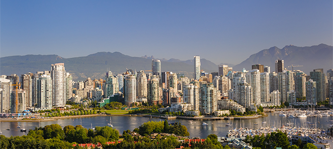 Skyline of downtown Vancouver on a clear summer day, with high-rise buildings in the foreground, sailboats in False Creek, and the North Shore Mountains in the background. Skyline of downtown Vancouver on a clear summer day, with high-rise buildings in the foreground, sailboats in False Creek, and the North Shore Mountains in the background.