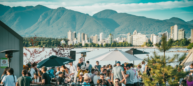 People sitting at a patio in front of the mountains in Vancouver's Kits neighbourhood People sitting at a patio in front of the mountains in Vancouver's Kits neighbourhood