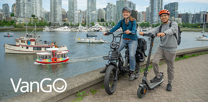 VanGo - people walking their bikes at an intersection