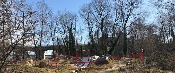 Fenced off dirt jump in front of a tree with an eagle's nest in Vanier Park Fenced off dirt jump in front of a tree with an eagle's nest in Vanier Park