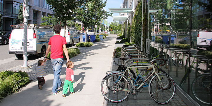 Parent walking with 2 toddlers in the Creekside area