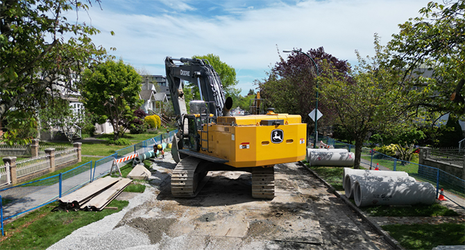 A excavator digging up a roadway A excavator digging up a roadway