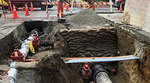 water pipe construction showing worker near dug out road