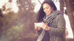 Woman holding and looking at smartphone Woman holding and looking at smartphone