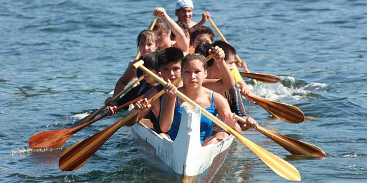 Indigenous youth paddling in the Coast Salish Canoe Races