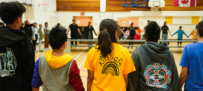 Young people linking hands together in a gymnasium